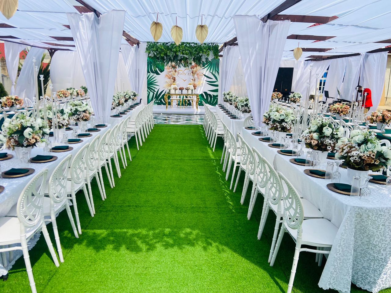 Full venue view with green and white theme and decorated aisle