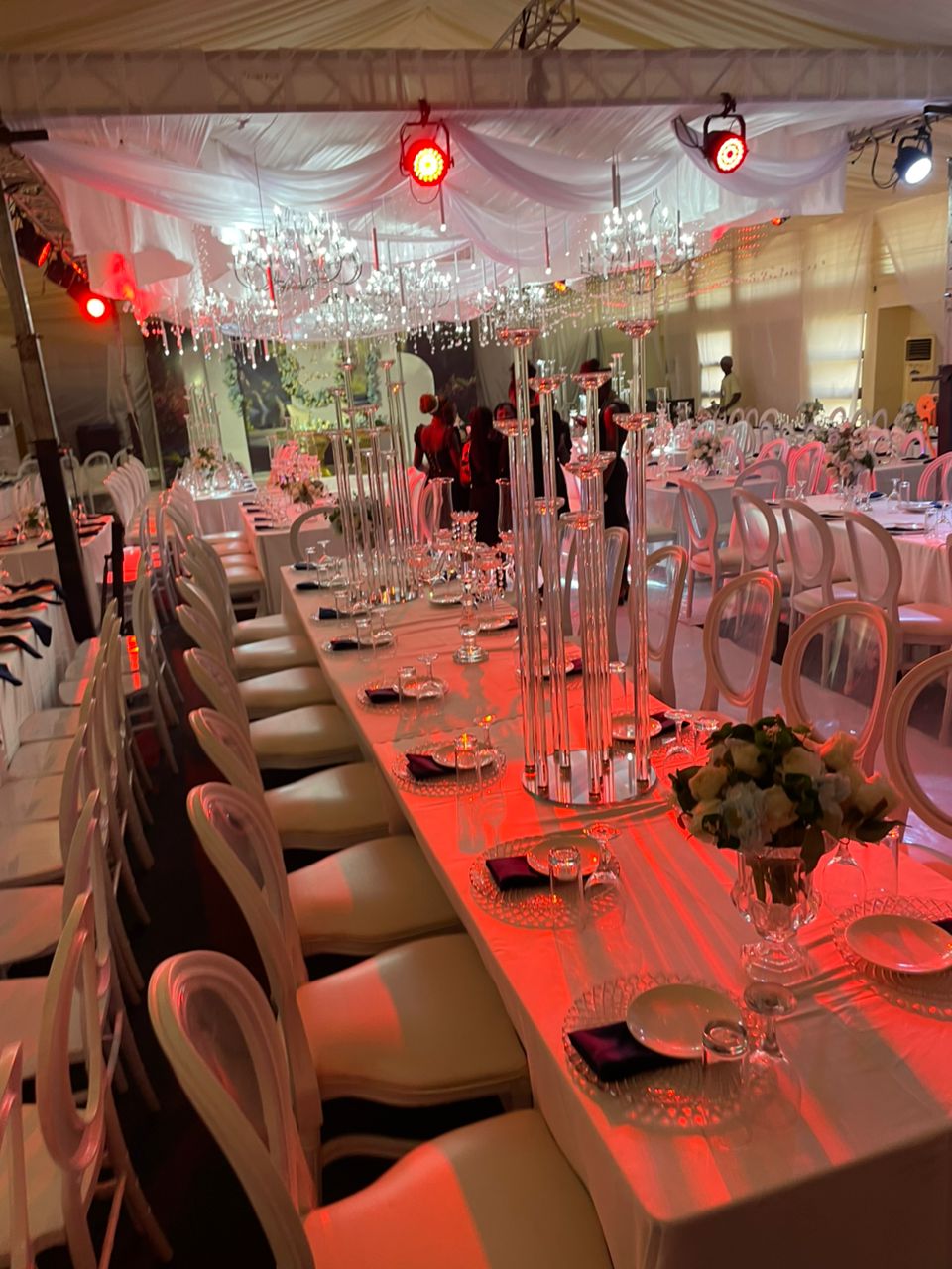 Red-lit dinner table with crystal candelabras for a dramatic ambiance