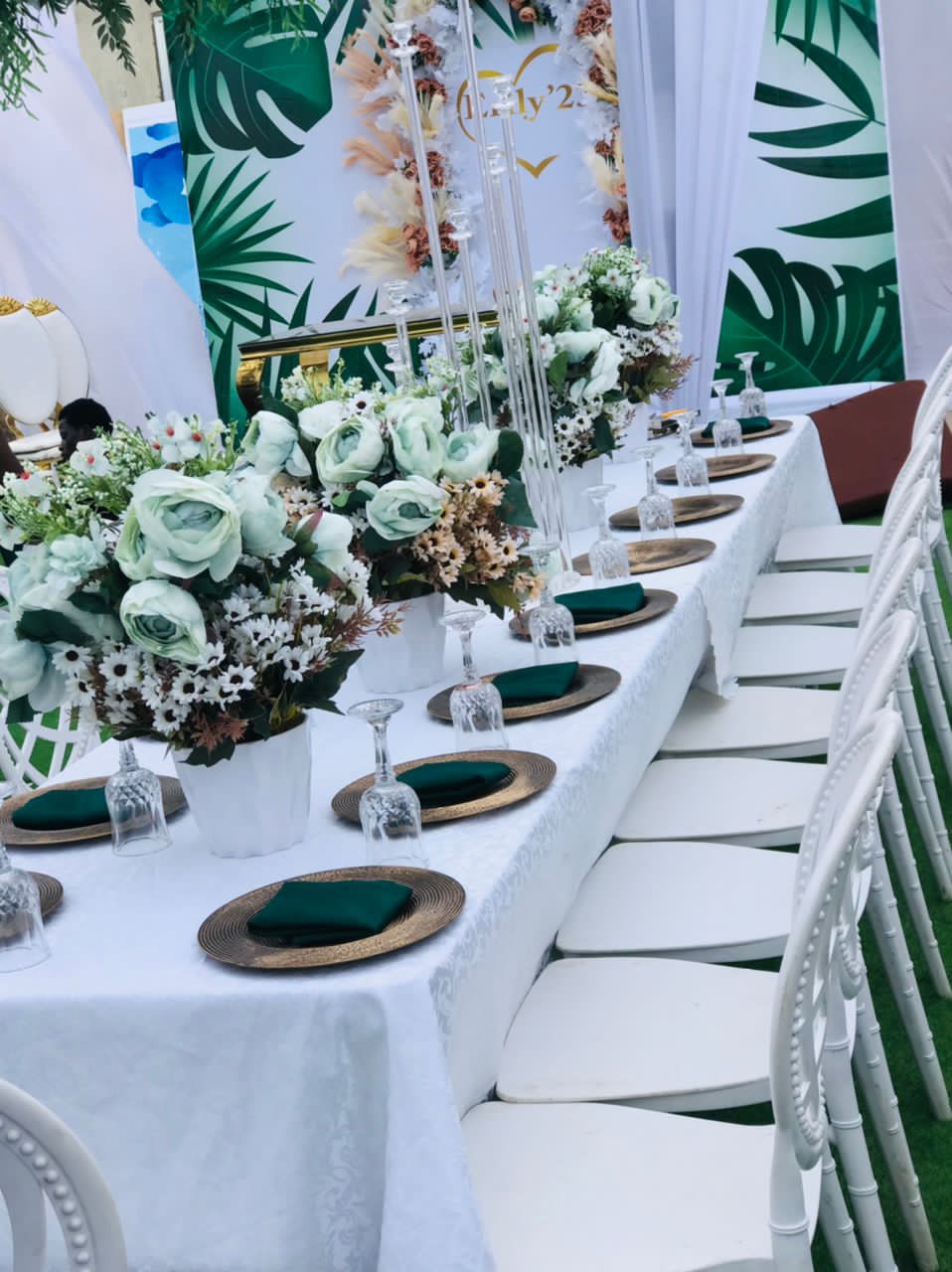 Green and white table setting with emerald napkins and floral details